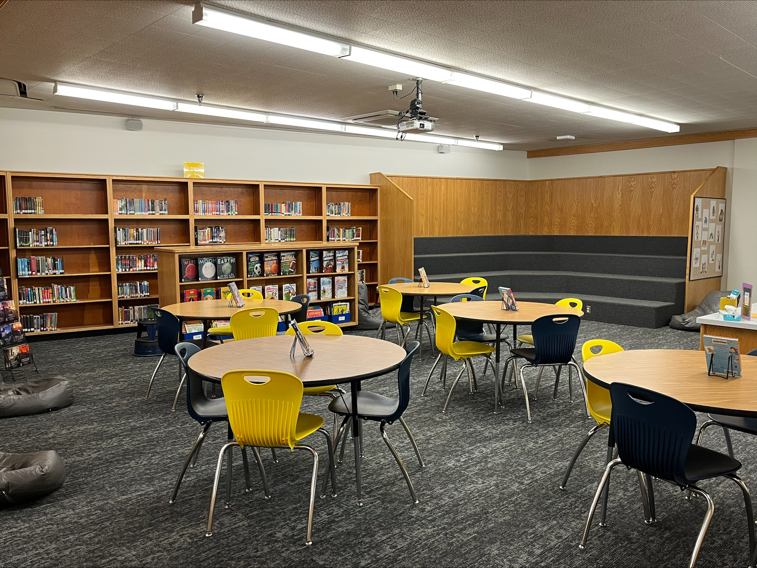 Tables, chair, bookshelves inside the library