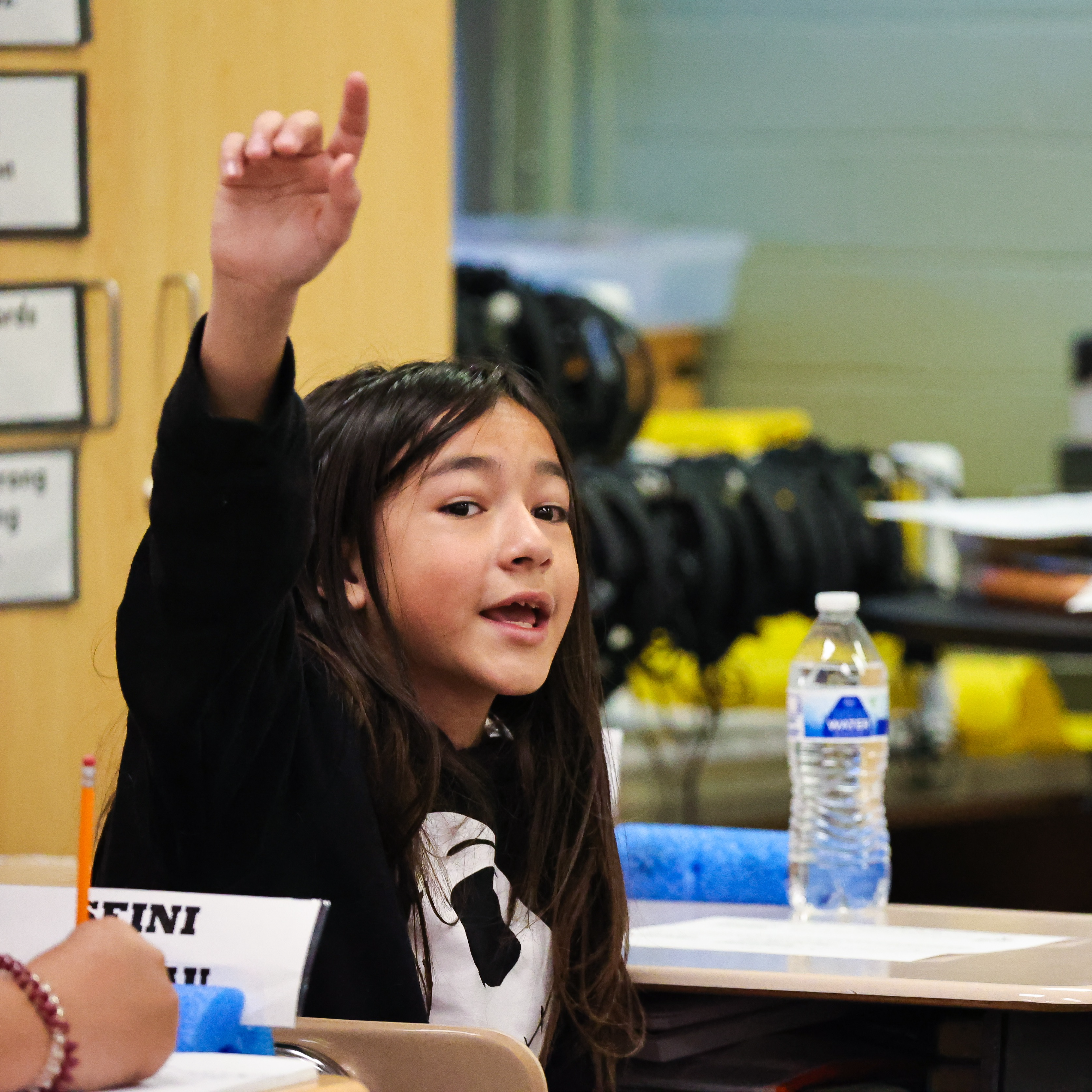 Student raising hand in class