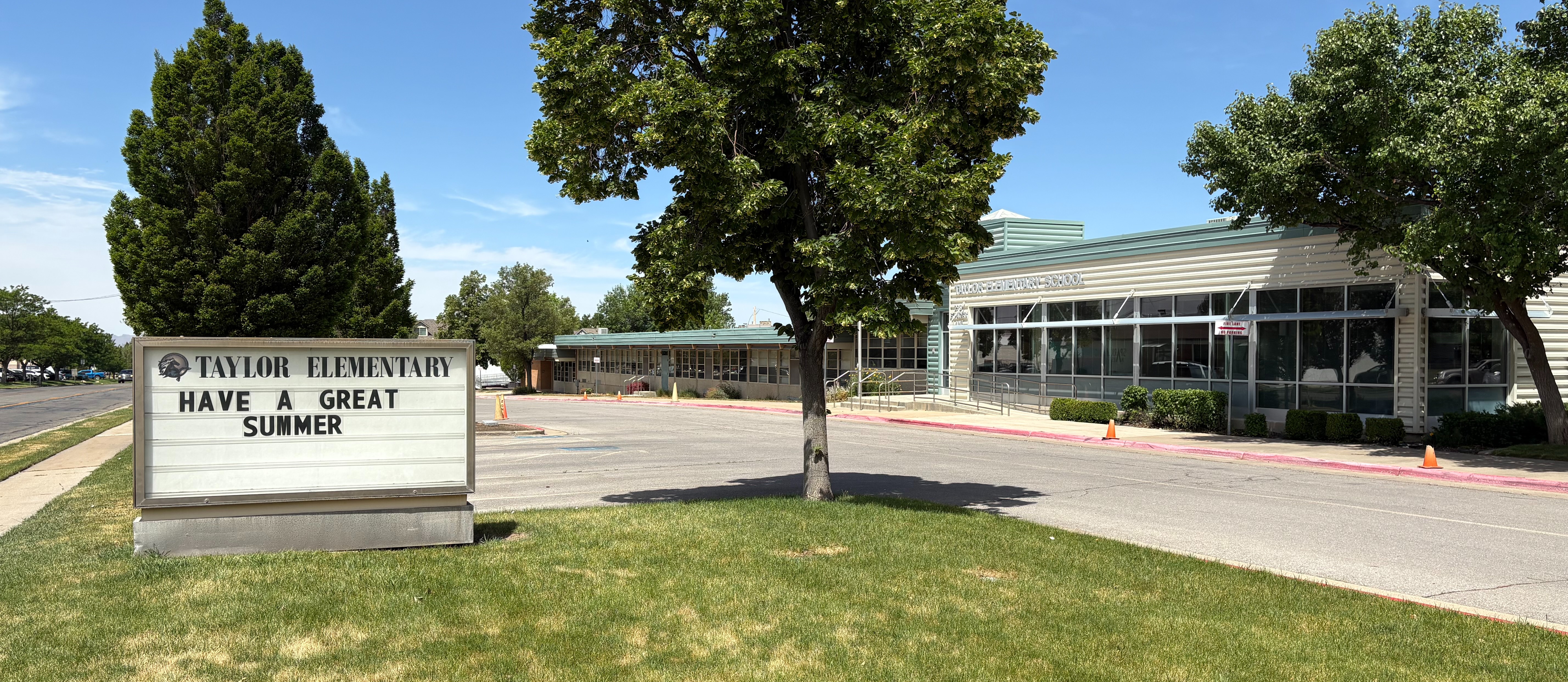 exterior side view of building with "Have a great summer!" sign