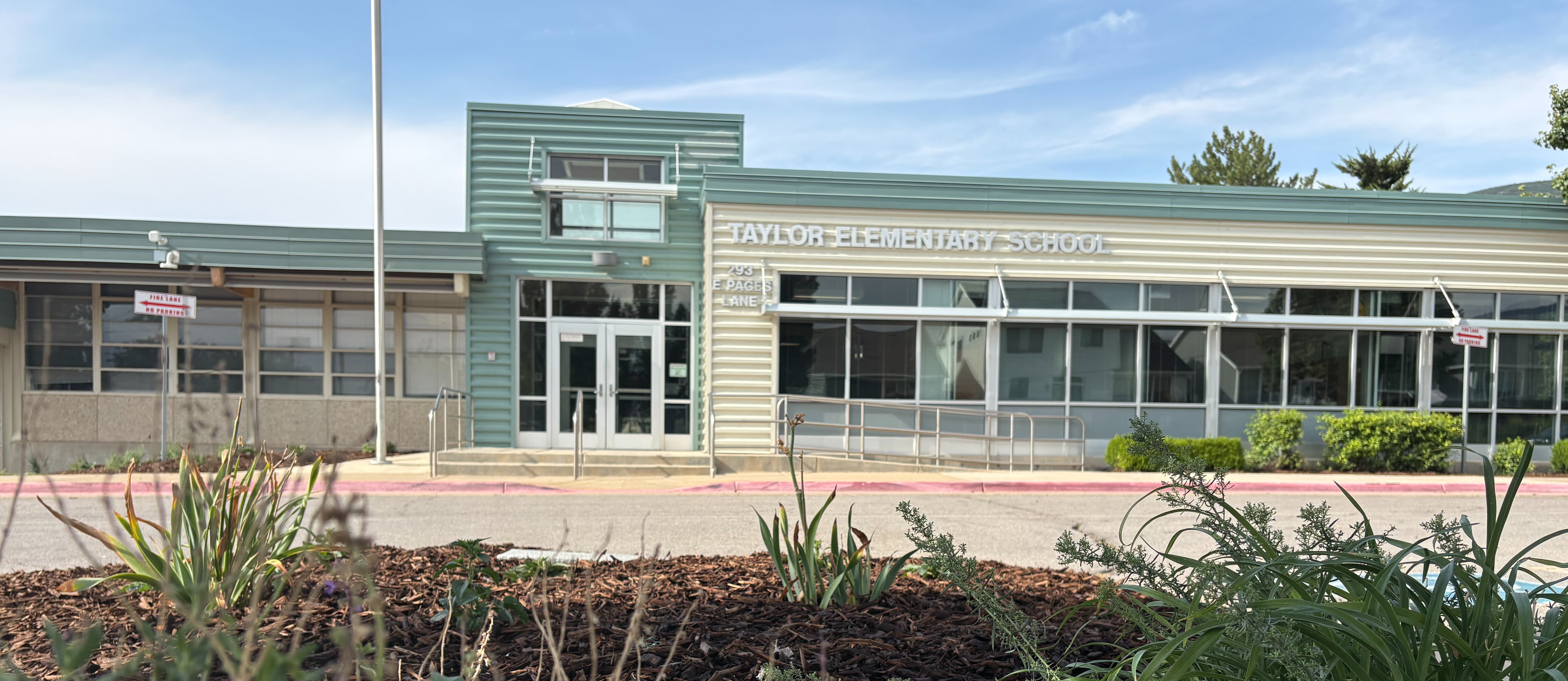 exterior front view of building with flowers in foreground