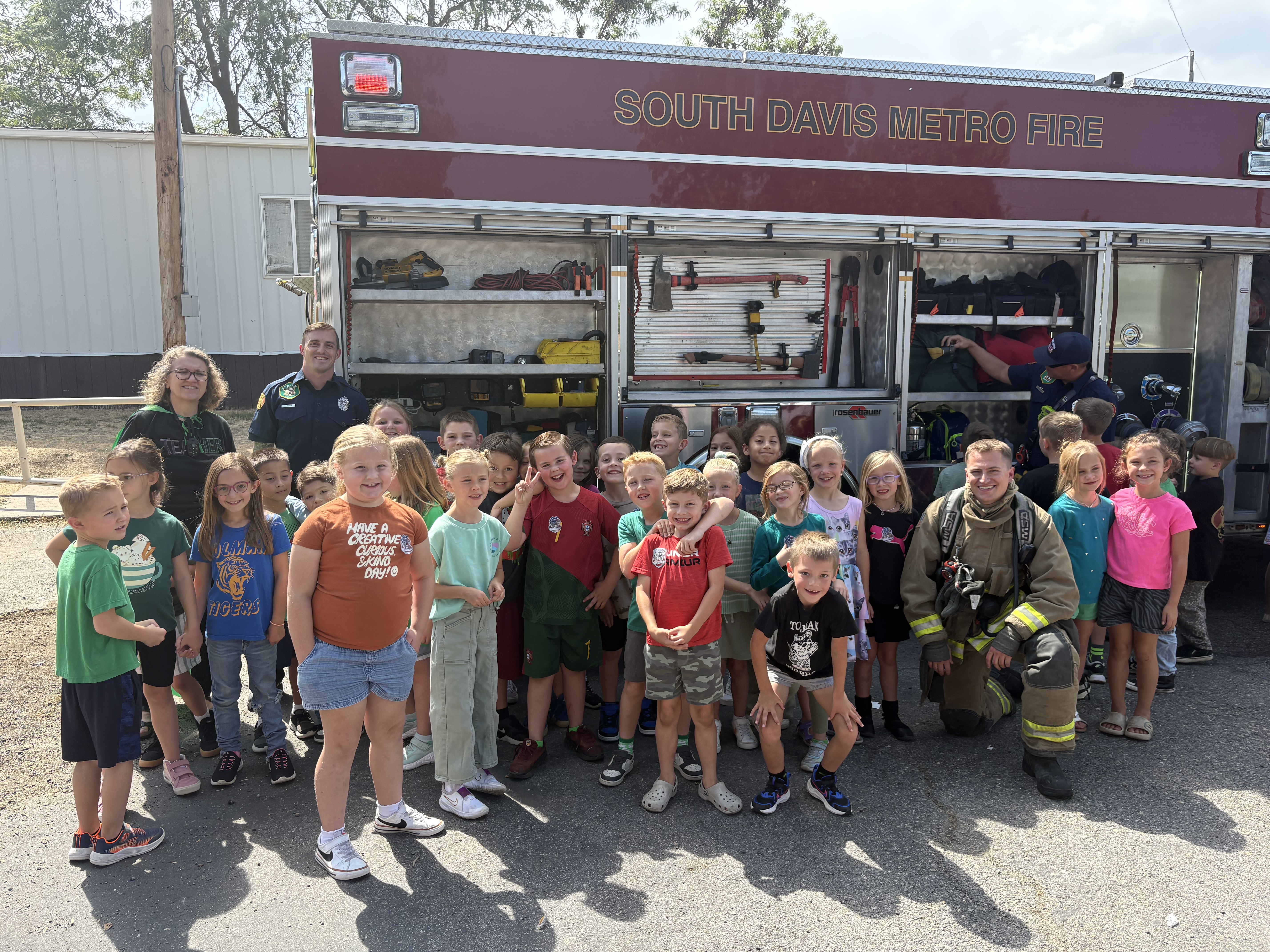 students in front of a fire truck
