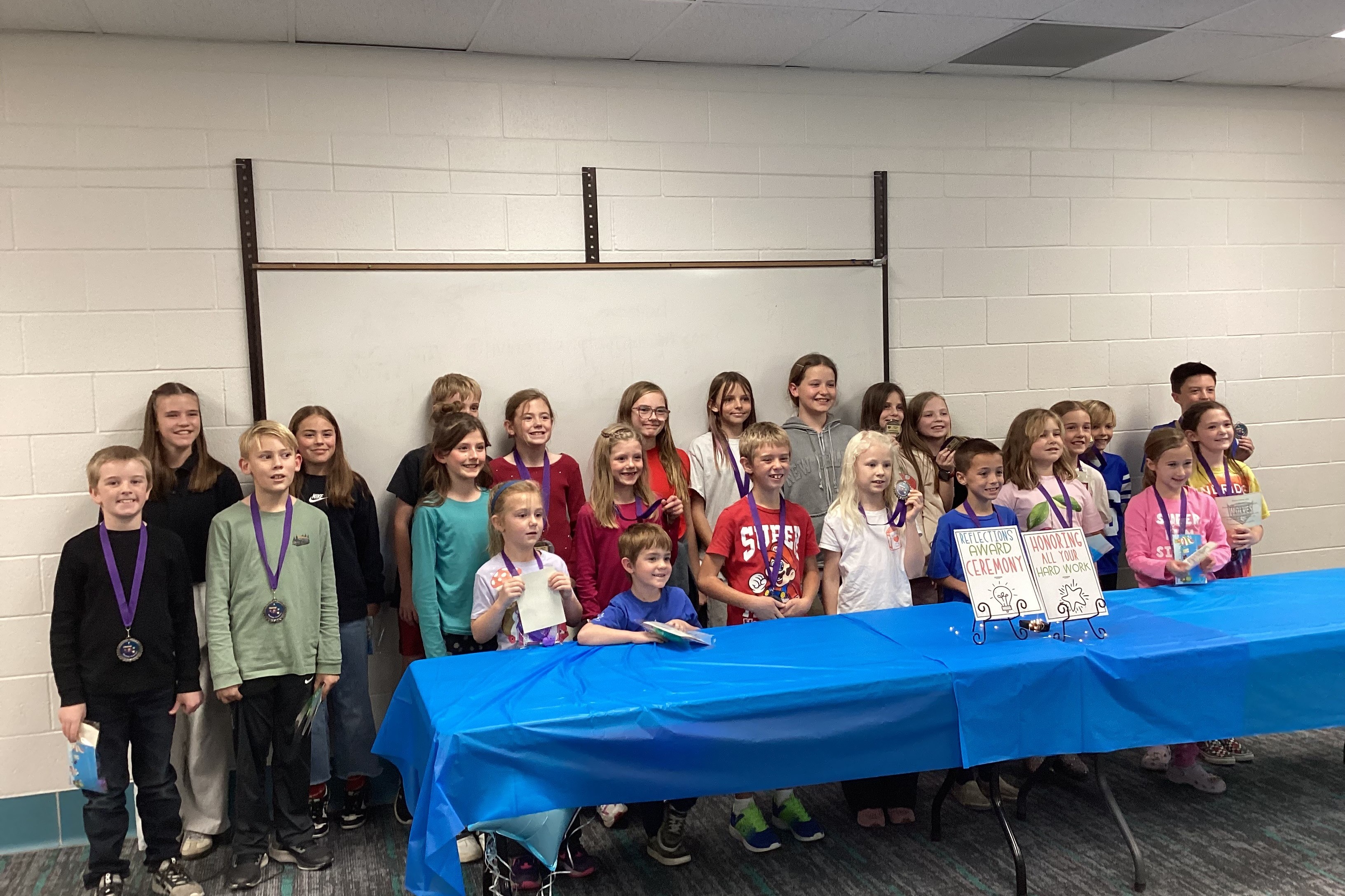 Kids in a group wearing medals after an awards ceremony