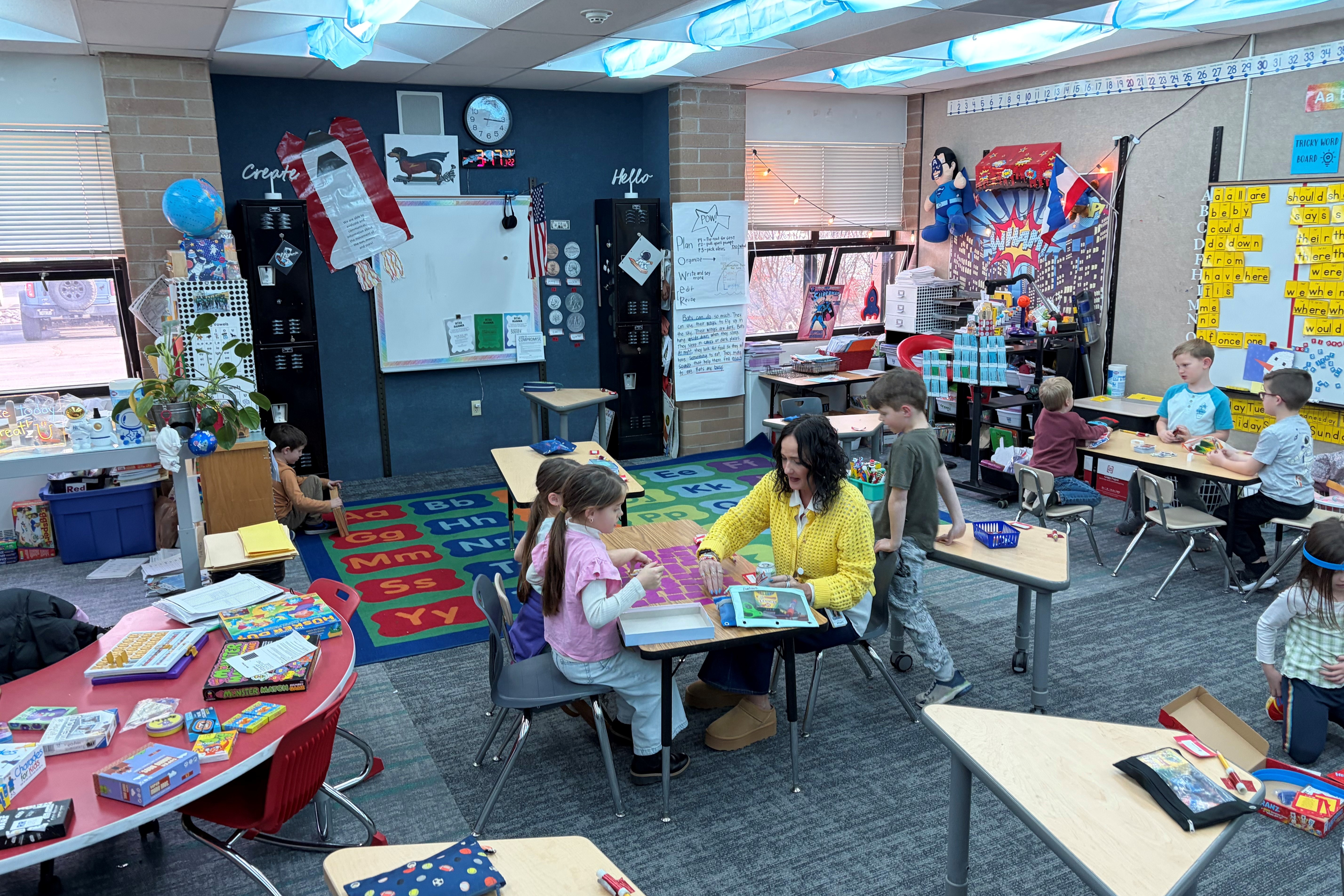 Kids playing card games with teacher
