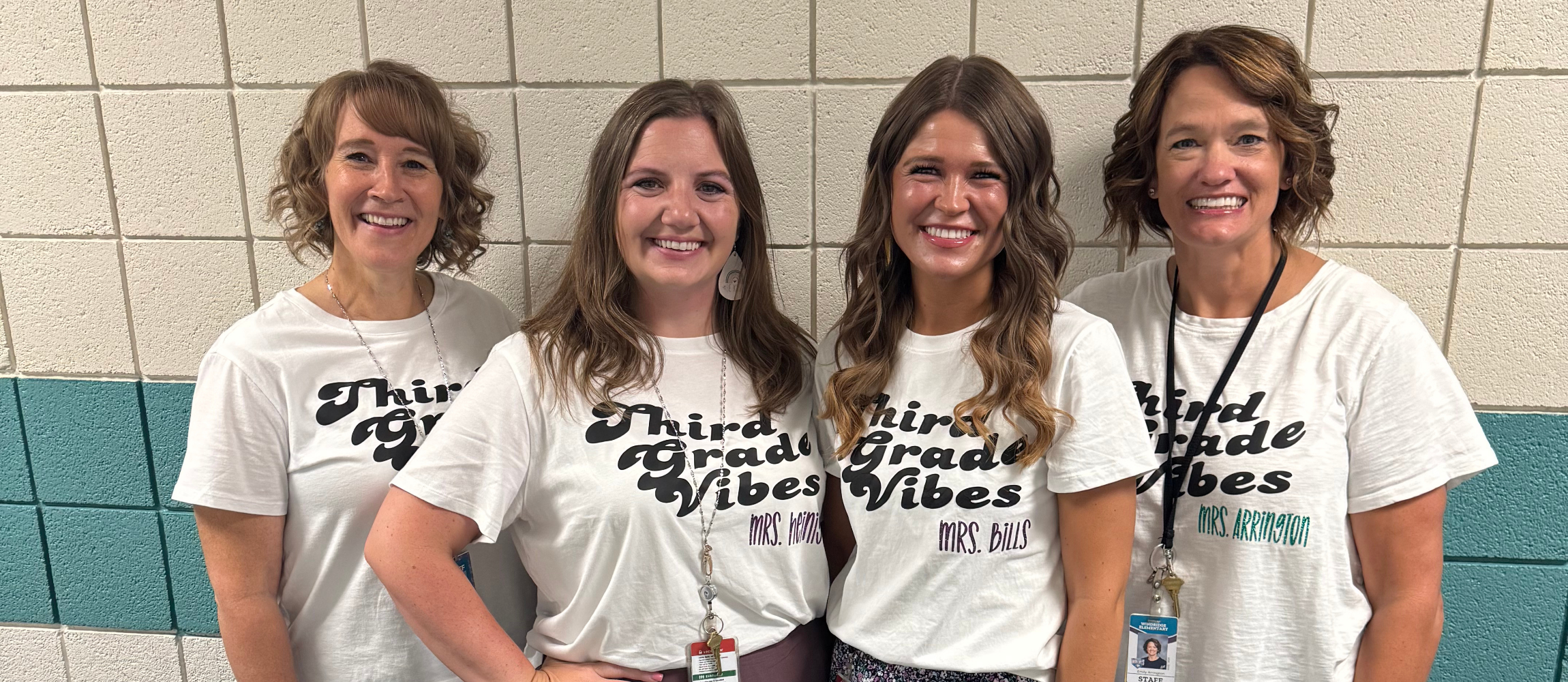 Teachers posing in matching shirts
