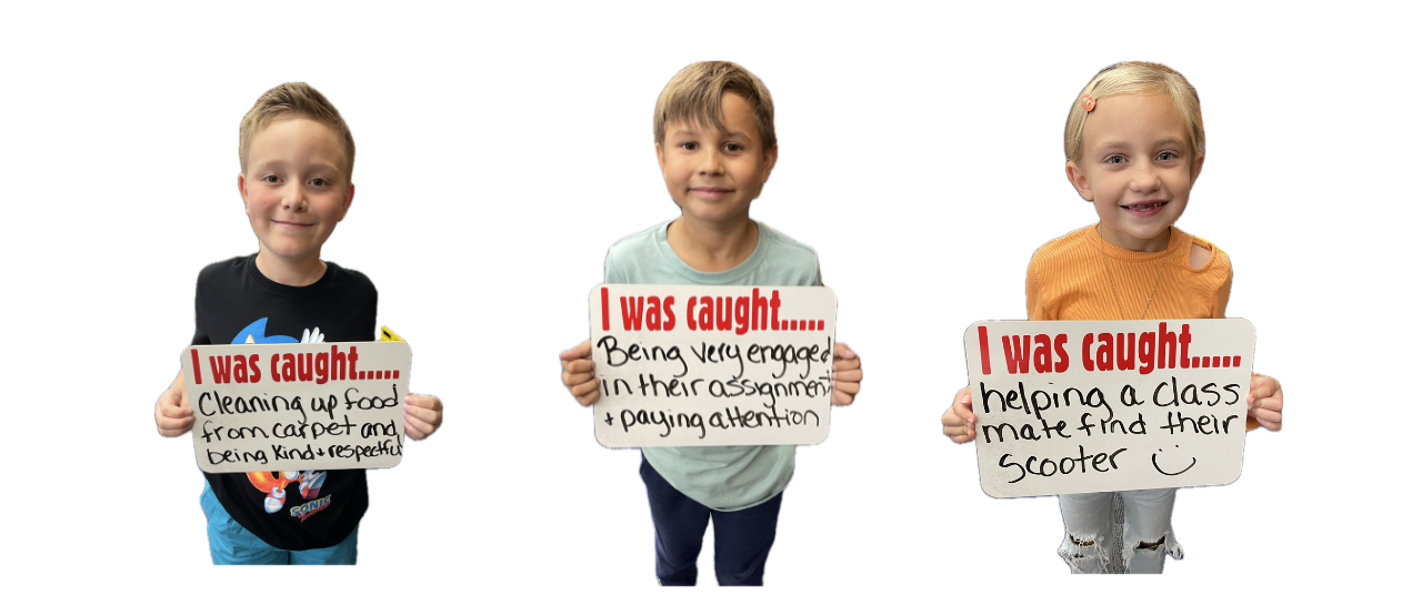 Three students holding signs that say:  I was caught..cleaning up food from carpet and being kind & respectful.  I was caught...being very engaged in their assignment and paying attention.  I was caught.... helping a classmate find their scooter.