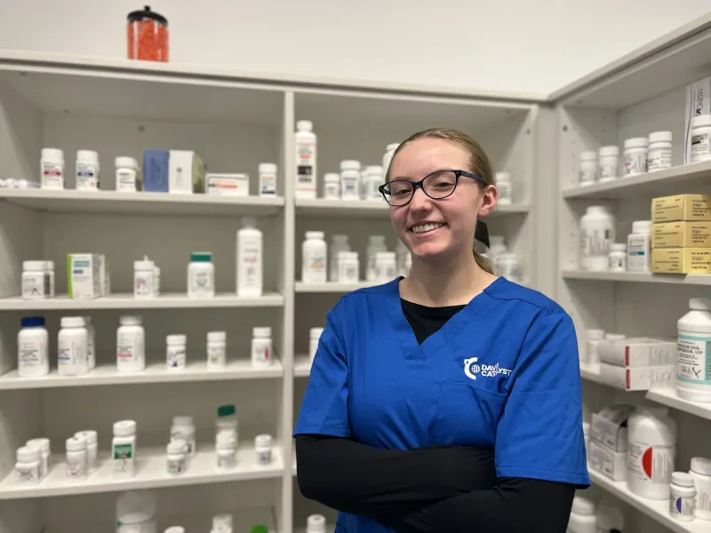 Pharmacy Tech student smiling in a pharmacy 