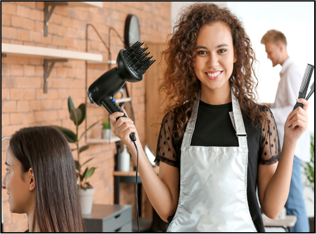 woman in a salon holding a hair dryer