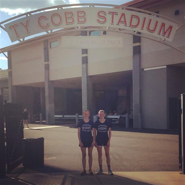 Two people standing in front of a stadium