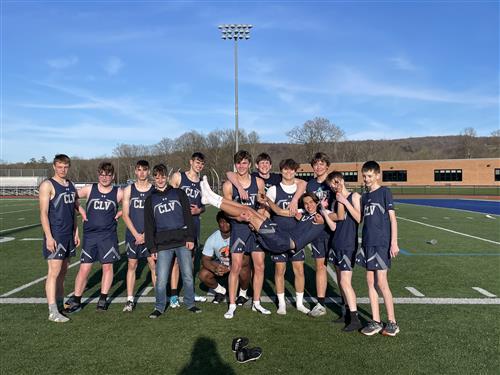 A group of young men standing next to each other on a field