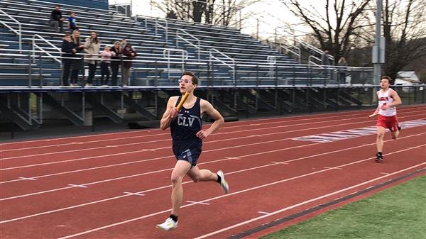 A couple of people that are running on a track