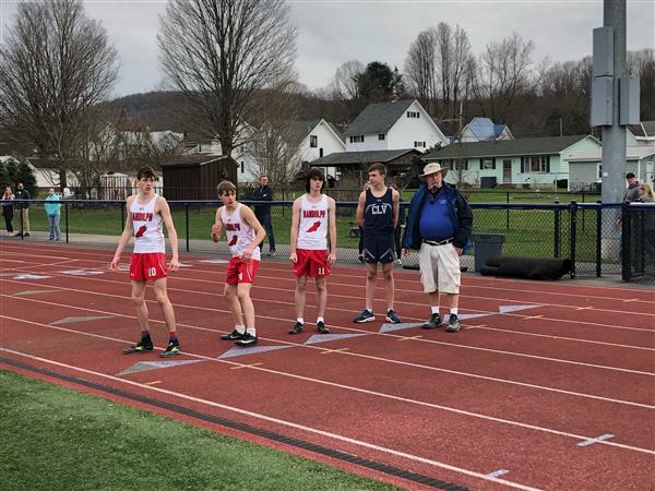 A group of young men standing on top of a track