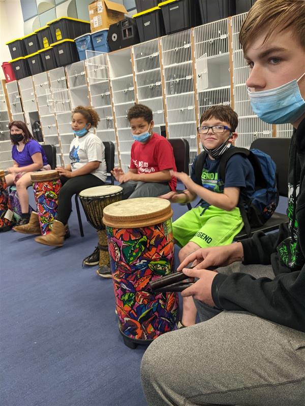 Students at the School of the Arts in New York learning to play the drums, honing their musical skills.