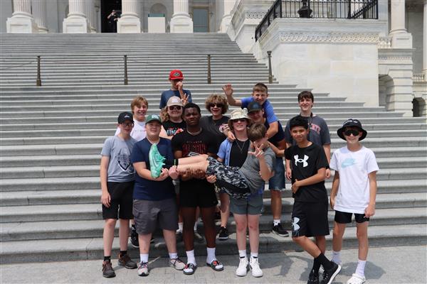 Group of boys and girla taking group picture