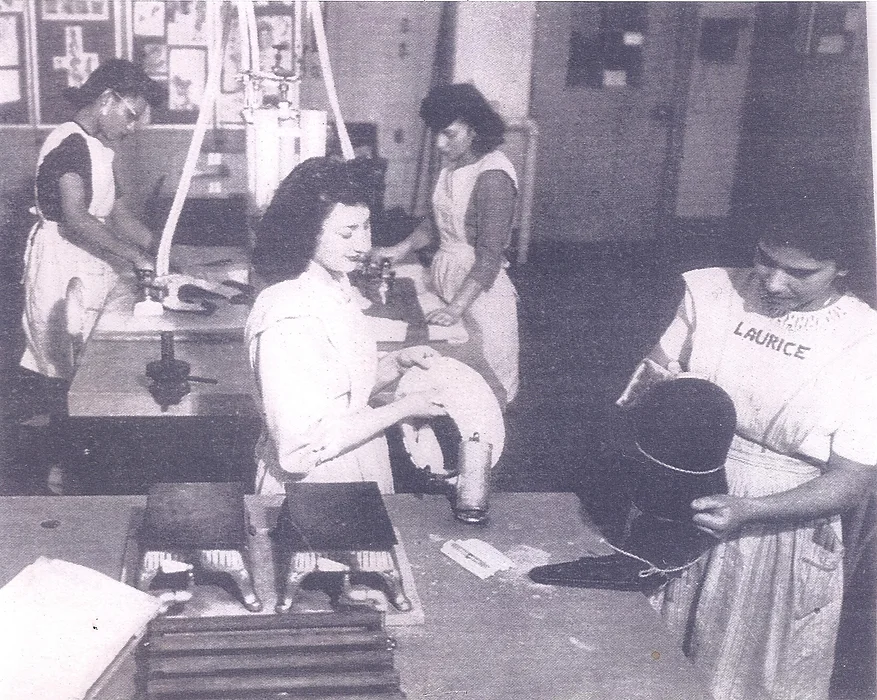 vintage black and white photo of women working in a seamtress' shop