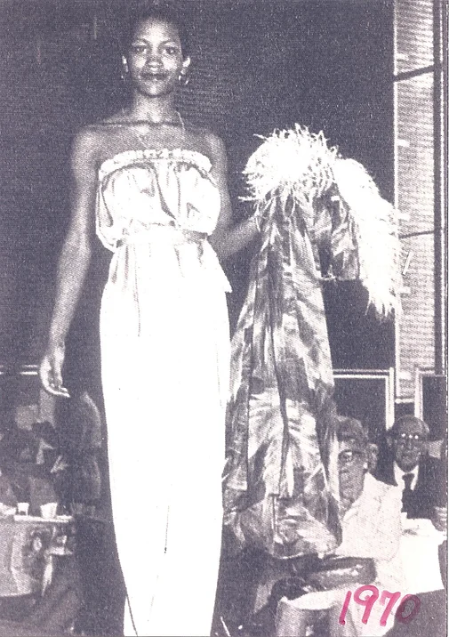 black and white 1970s photo of a woman of color wearing a long light colored gown
