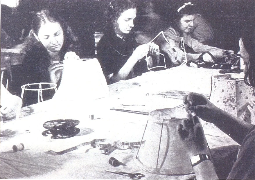 1960s black and white photo of several girls sitting at a table making lampshades