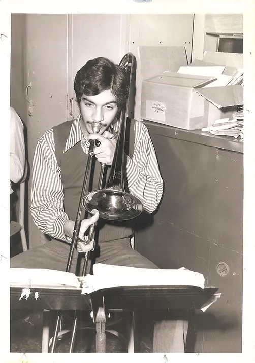 black and white 1970s photo of a young man playing trumpet