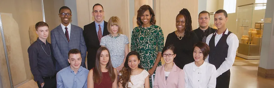 michelle obama posing with a small group of HSFI students and faculty