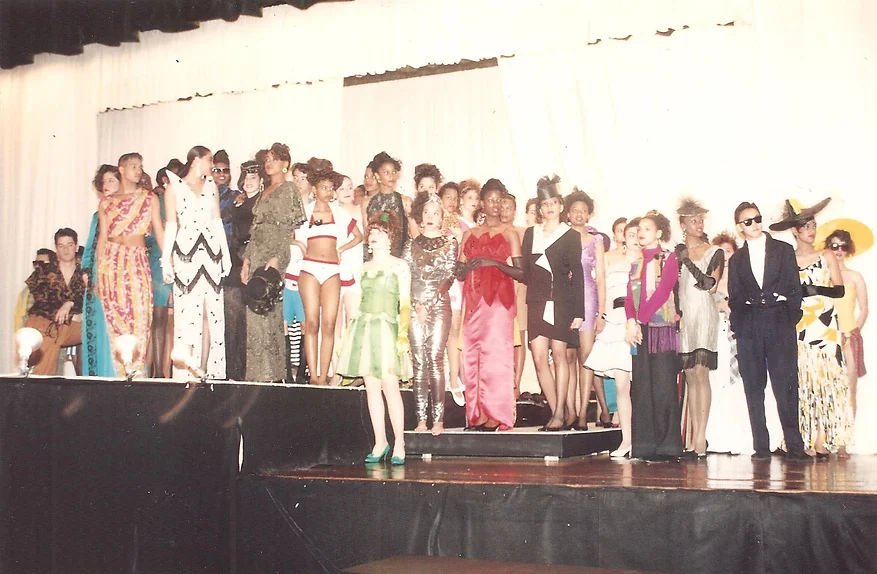 group shot of high school students on a stage in various different costumes
