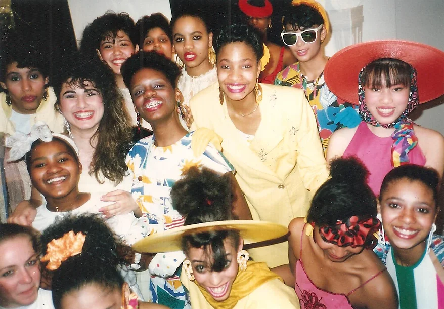 group photo of smiling 1980s teens in colorful clothes