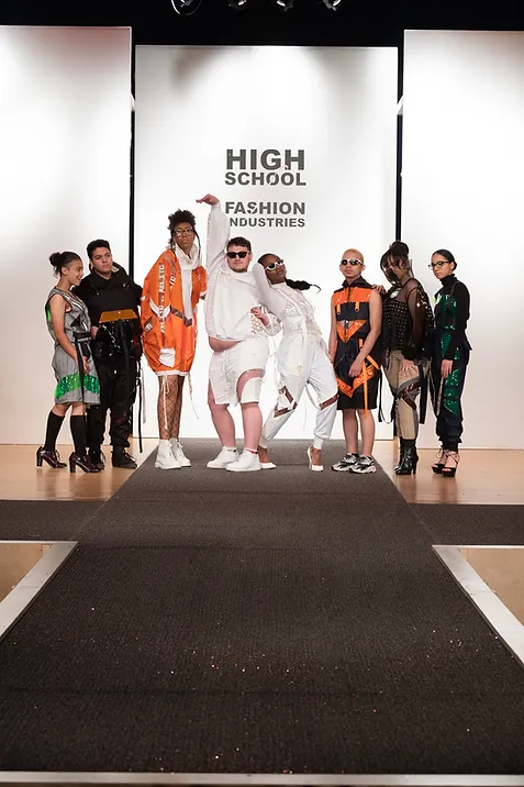 group of hsfi students posing at the bottom of a runway in futuristic outifts