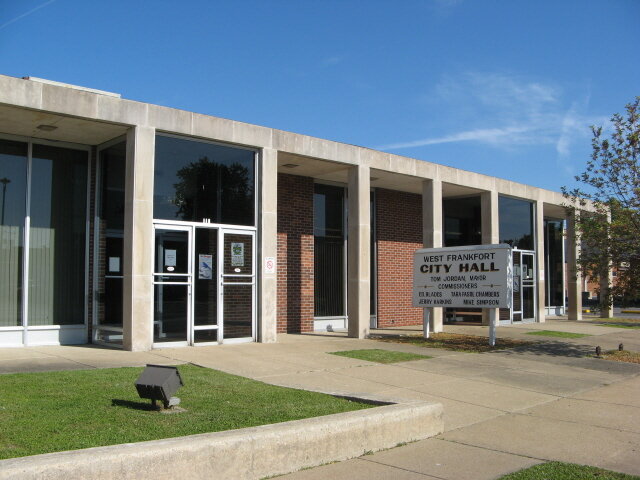 A modern, one-story building with large windows, featuring a sign for "Westmoreland" and an entrance door.