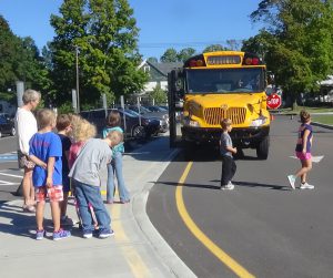 students waiting on school bus