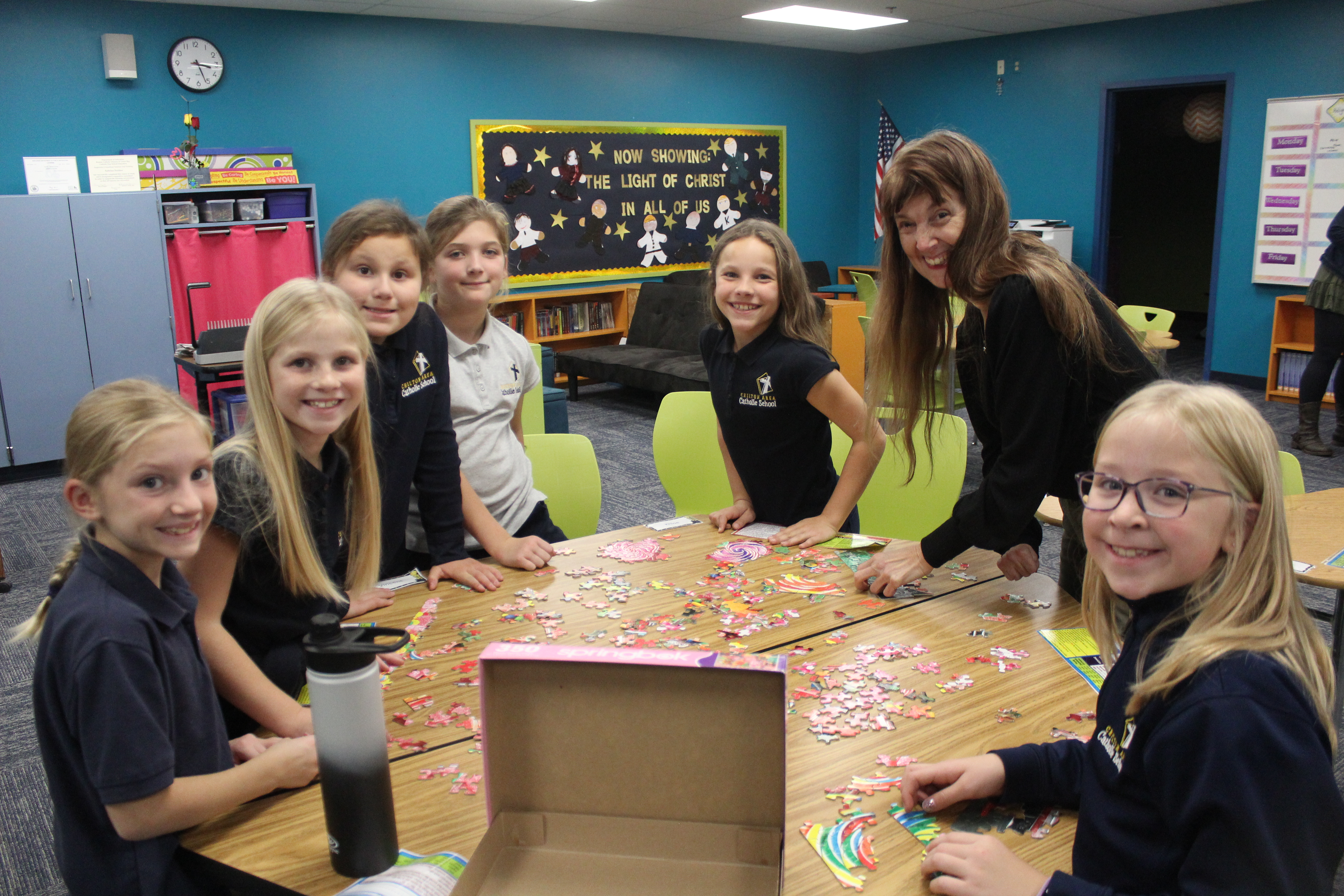 group of girls working on a puzzle