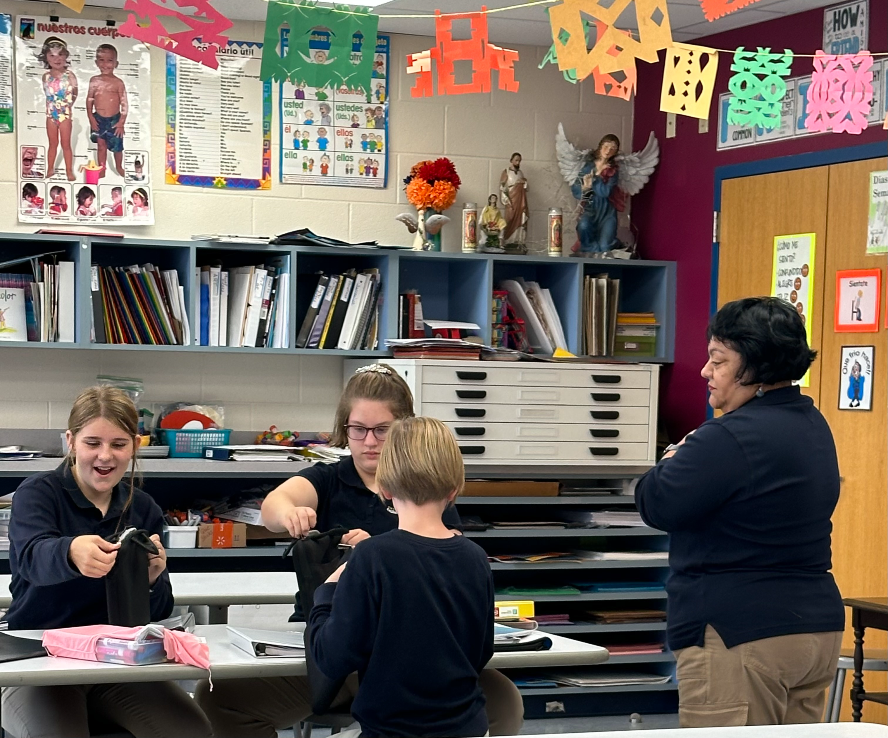 A teacher assisting students in a classroom