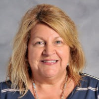 a woman wearing a blue tie-dye shirt