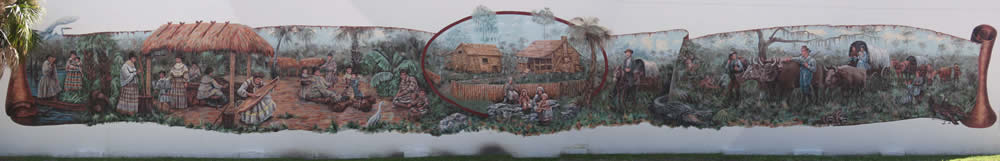 mural of villages in their home, doing activities such as creating crafts and taking care of bulls