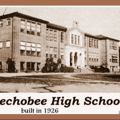 Black and white photo of Okeechobee High School, a multi-story brick building with many windows, built in 1926.
