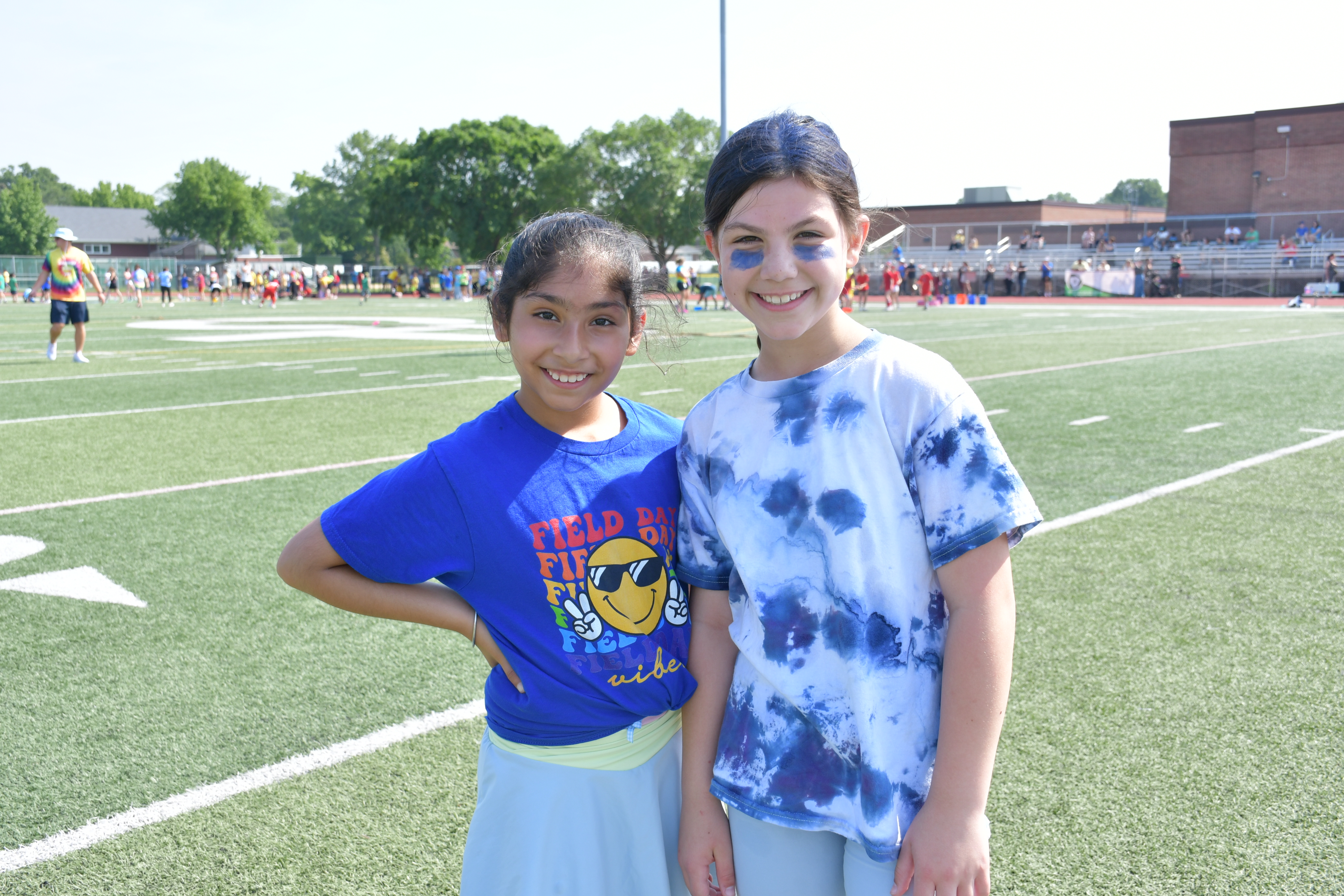 Students standing together dressed in blue.