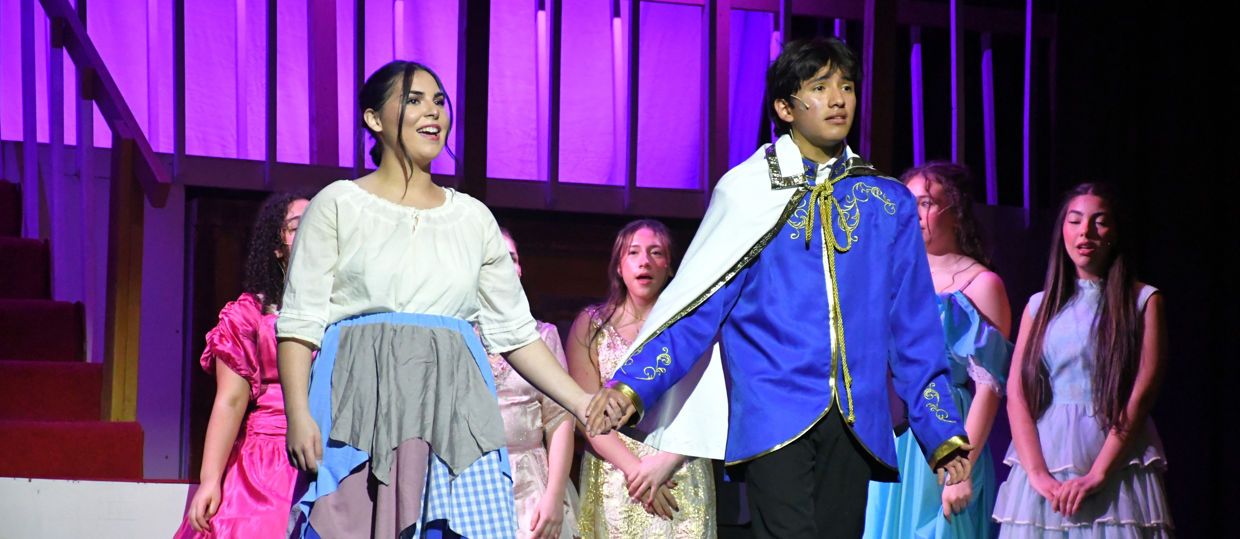 Students in costume on stage.