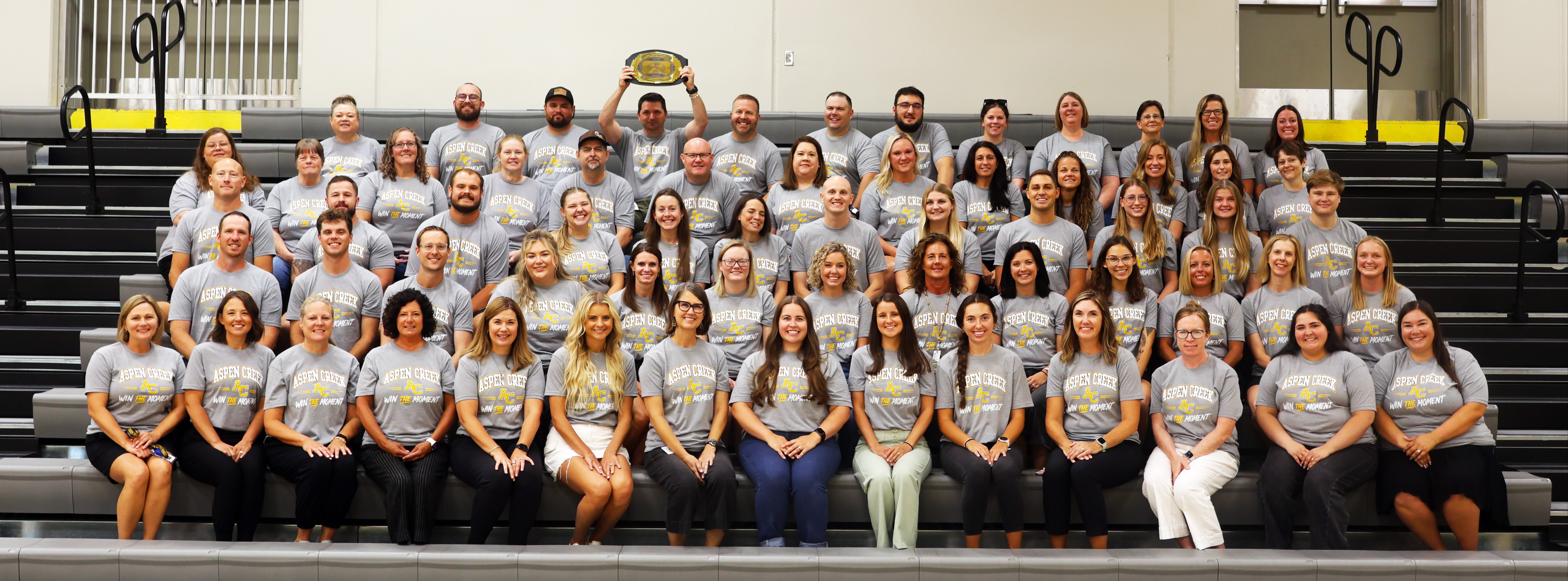 An all staff photo of Giles Creek Middle School staff on bleachers the day before school starts