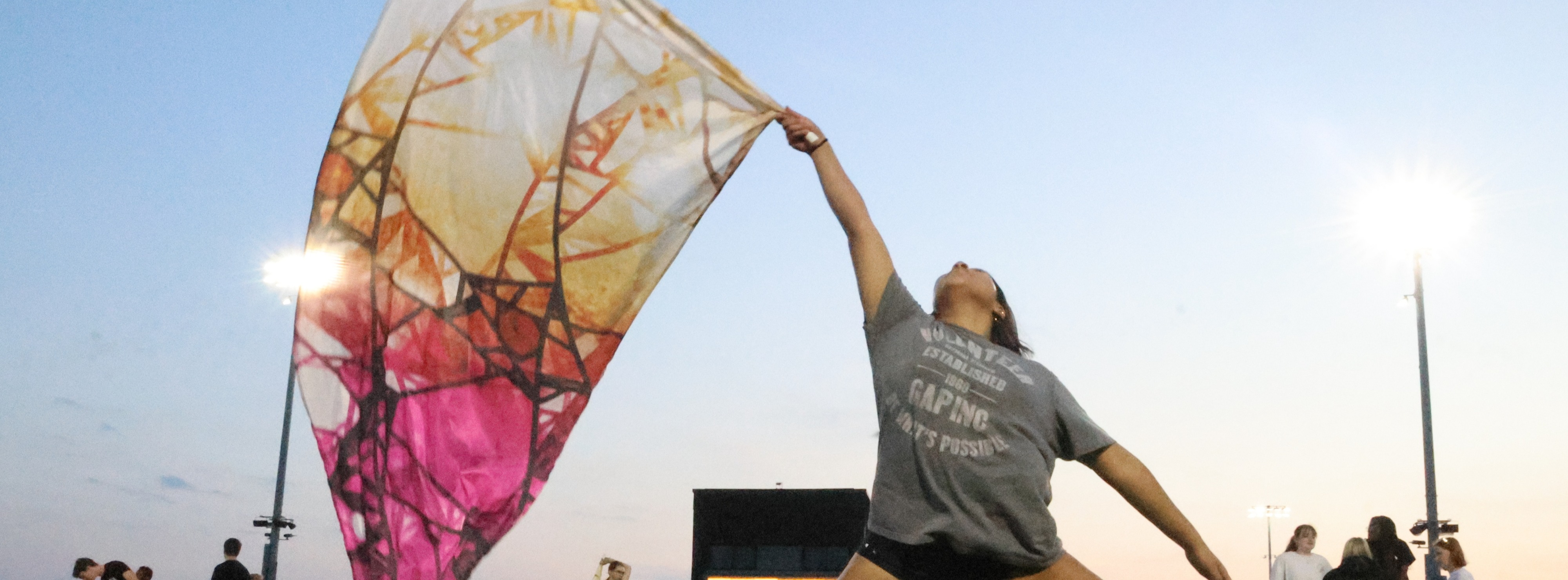 color guard waving flag on football field