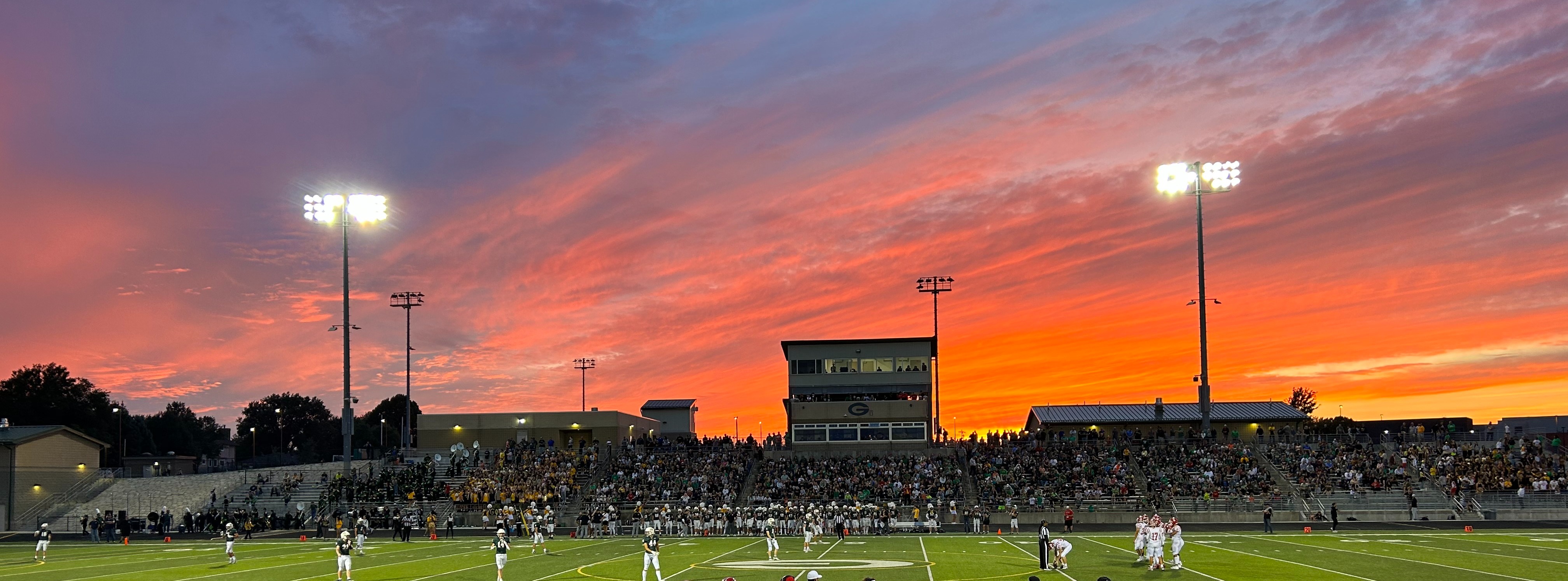 Sunset over Gretna High School stadium during a football game.