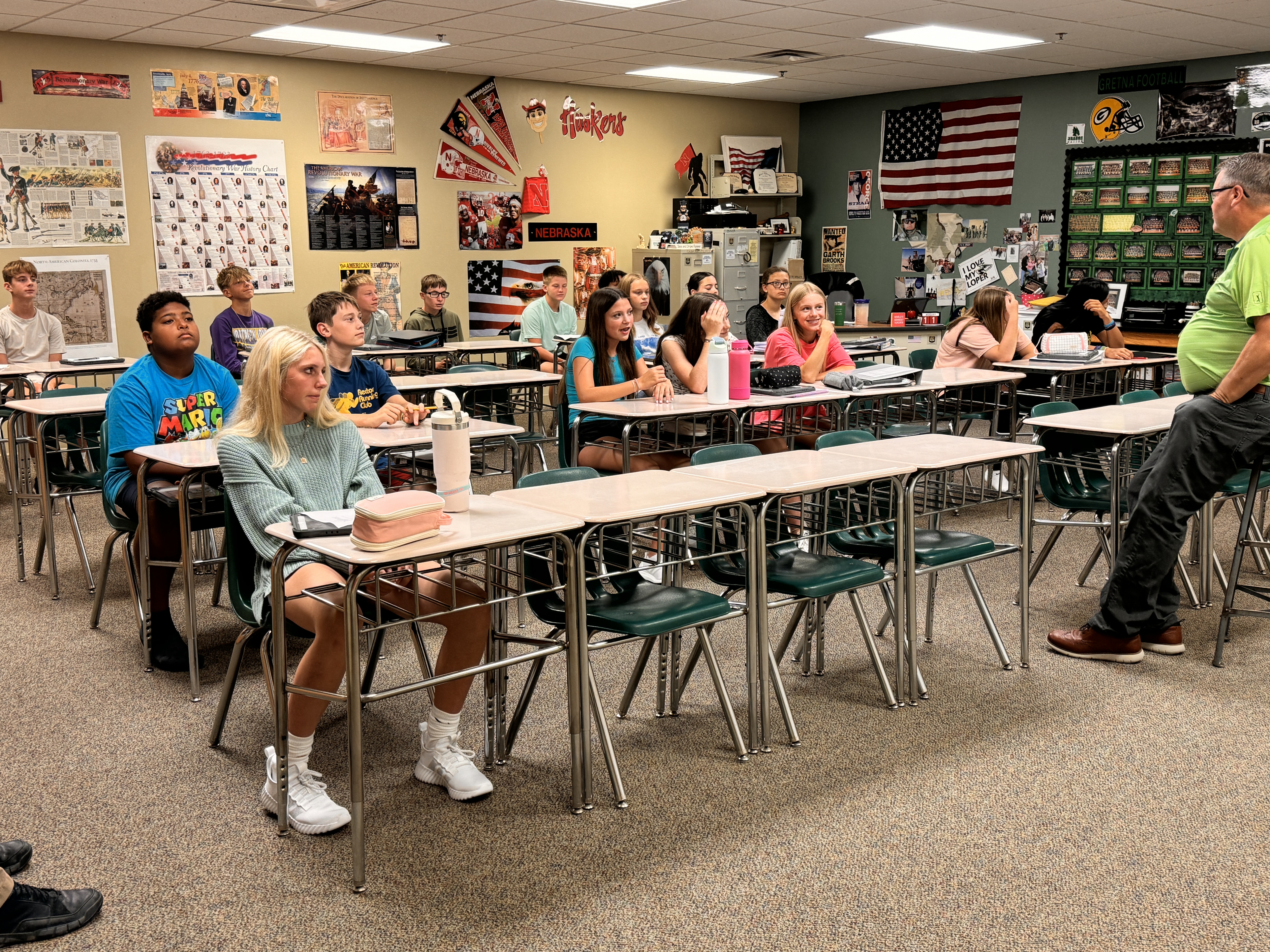 students at desks in classroom.