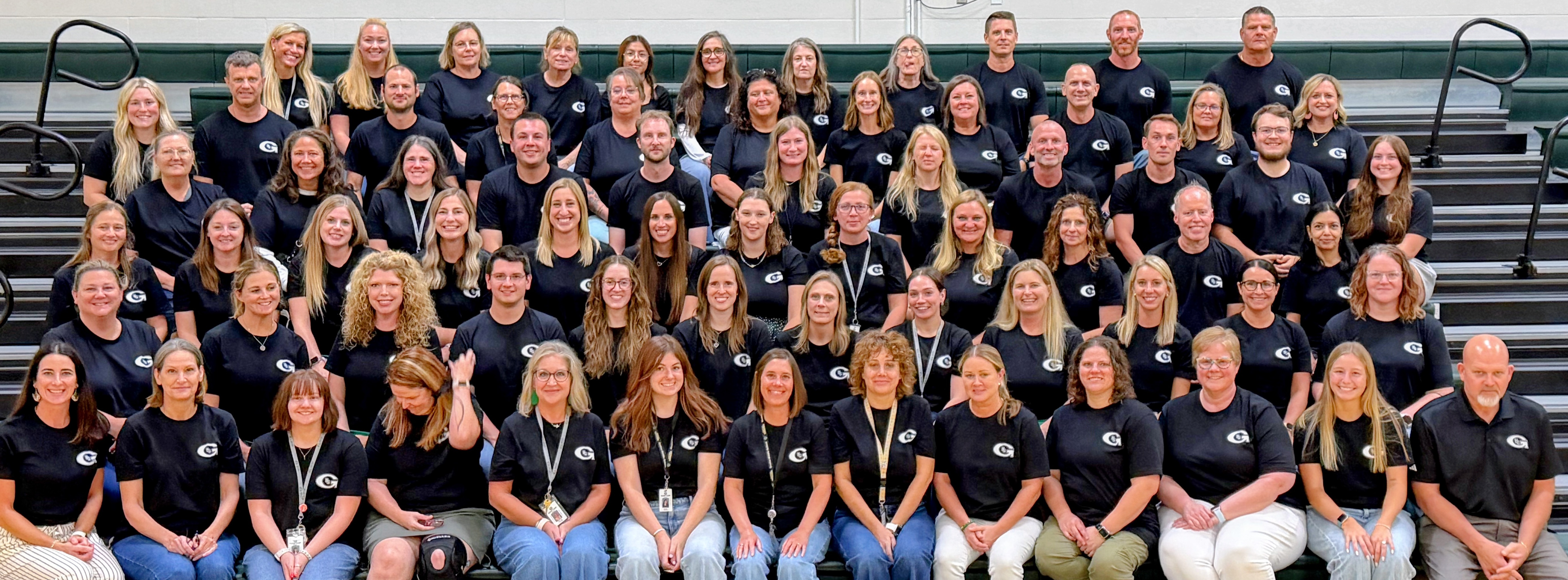 large photo of all Gretna Middle School staff sitting on bleachers the day before school starts