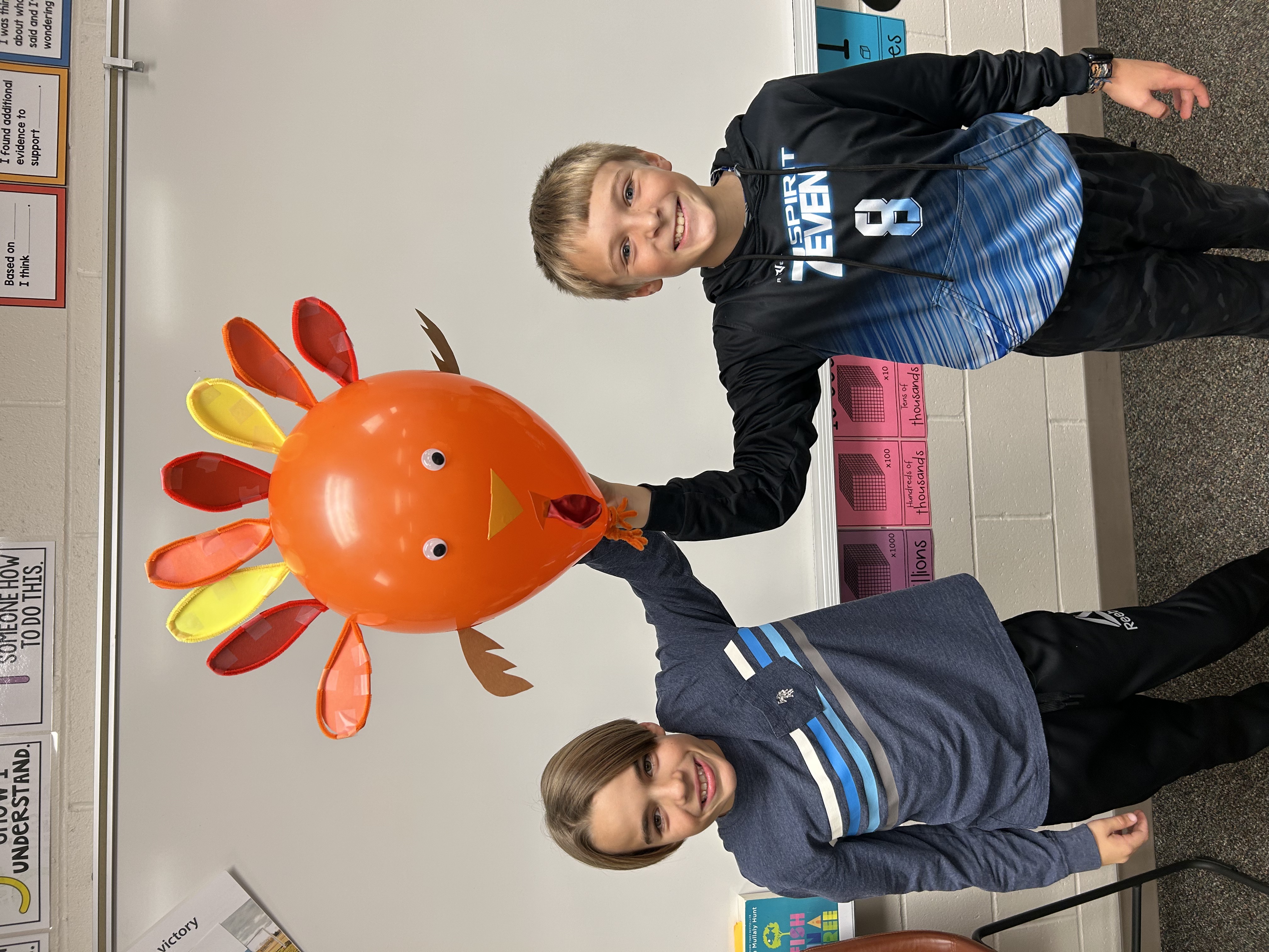 Two 5th Grade students holding their 'hot-air balloon' model for Thanksgiving. 