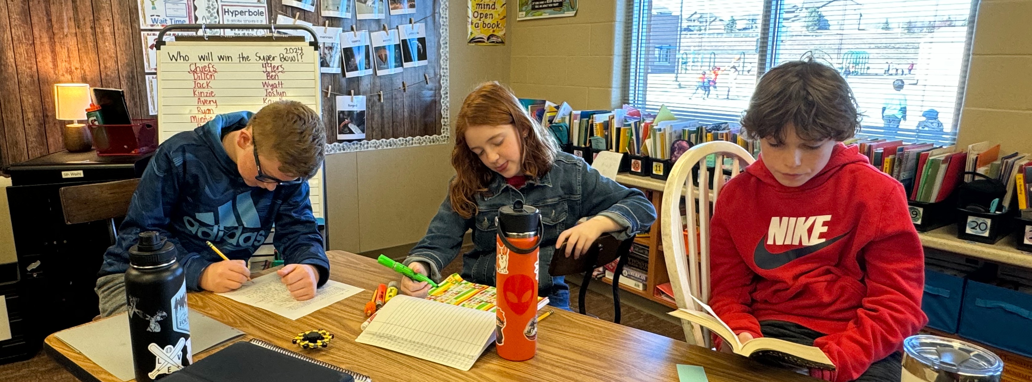 students reading at classroom desk