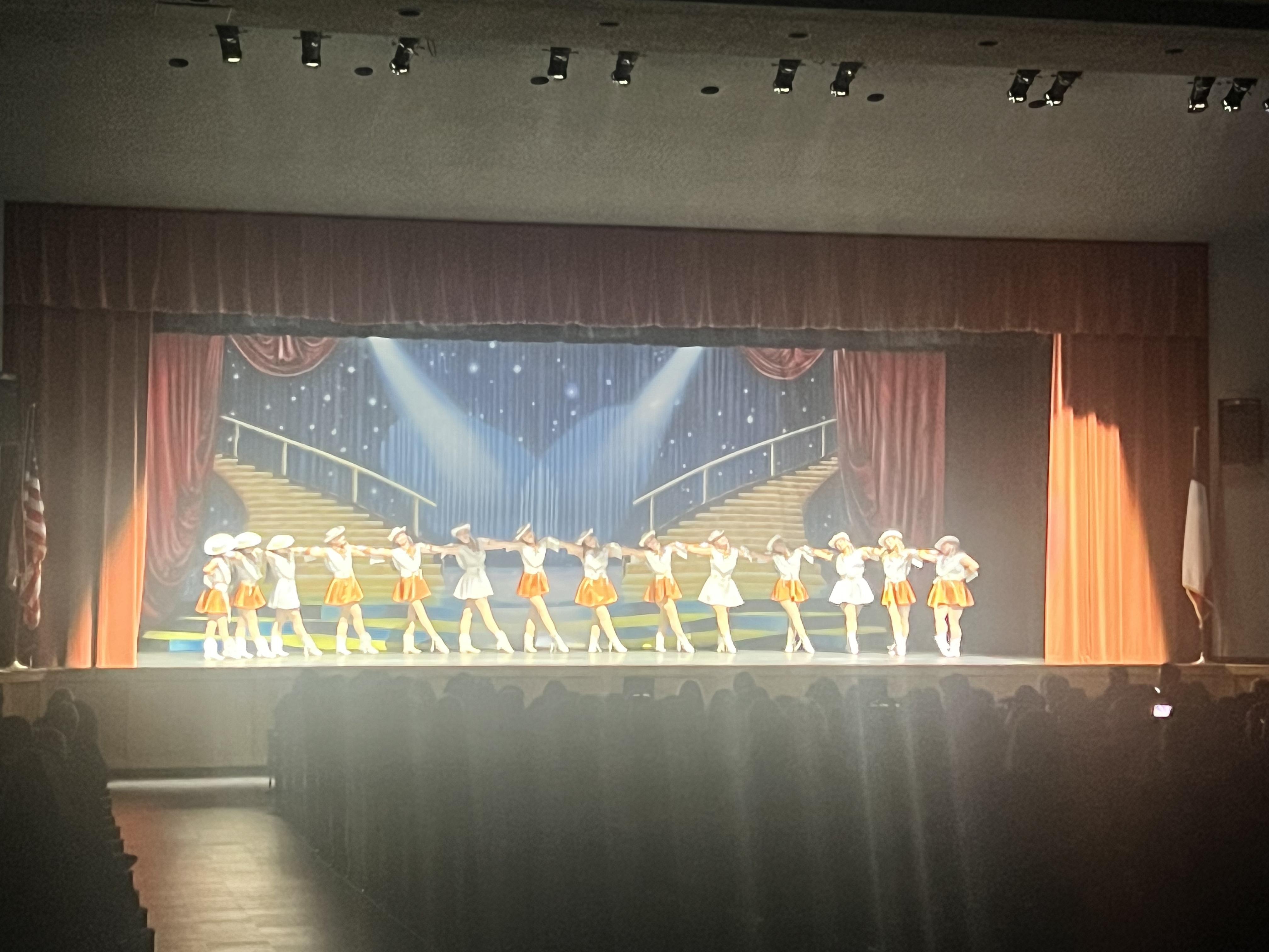 A group of people standing on top of a stage