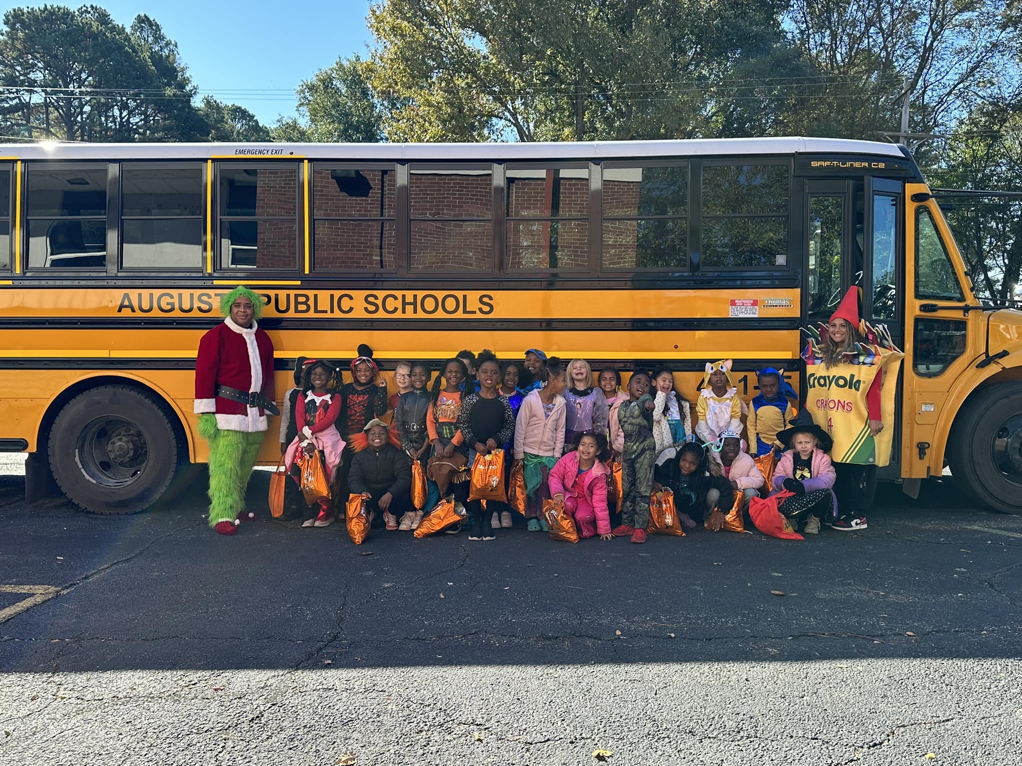 students in front of school bus