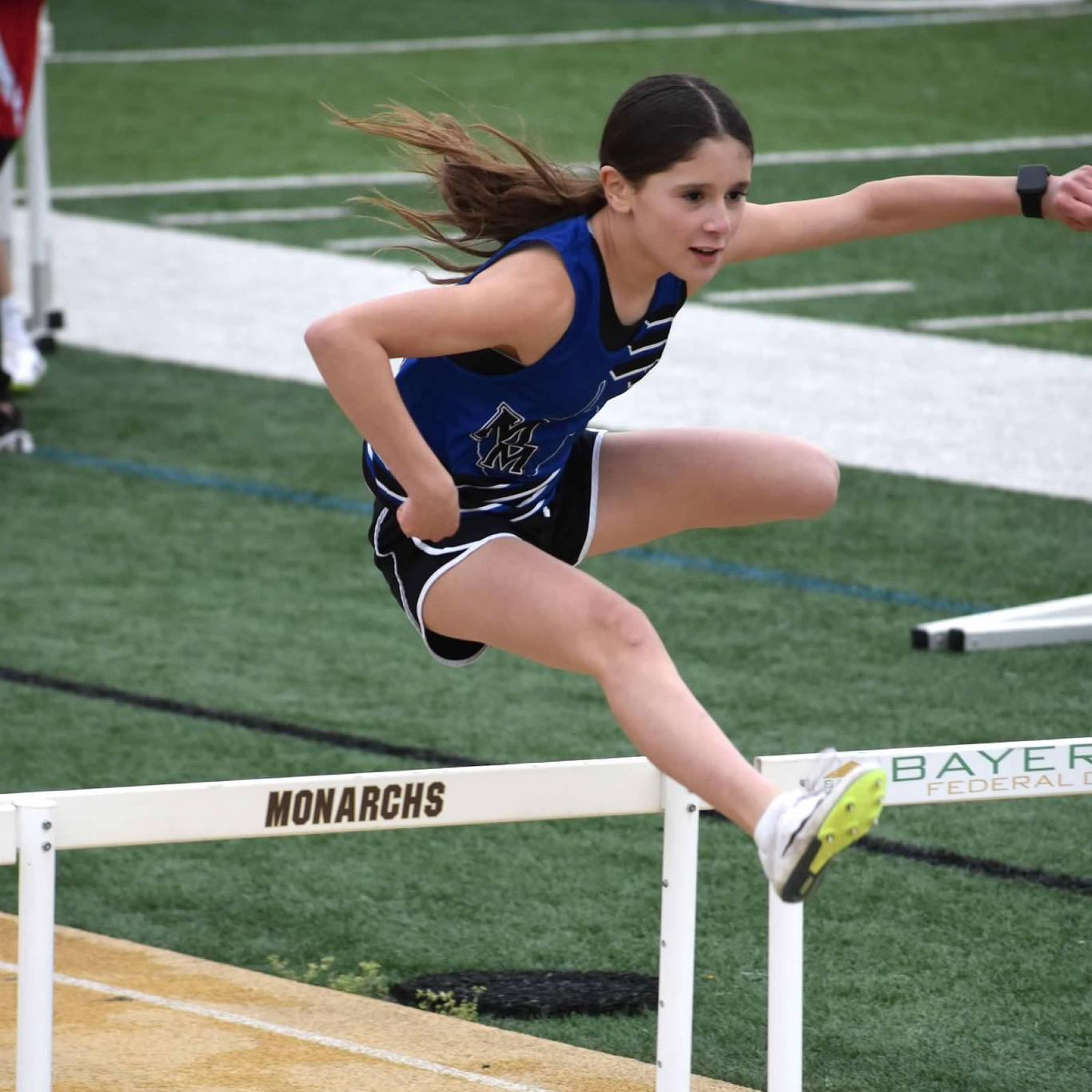 girl running hurdles