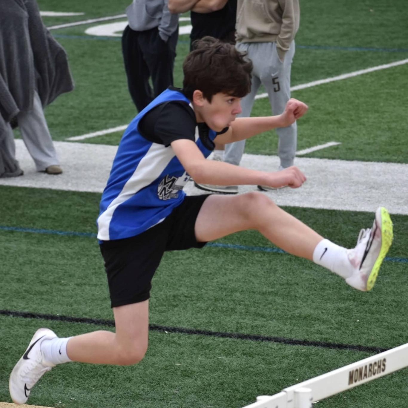 boy jumping hurdles