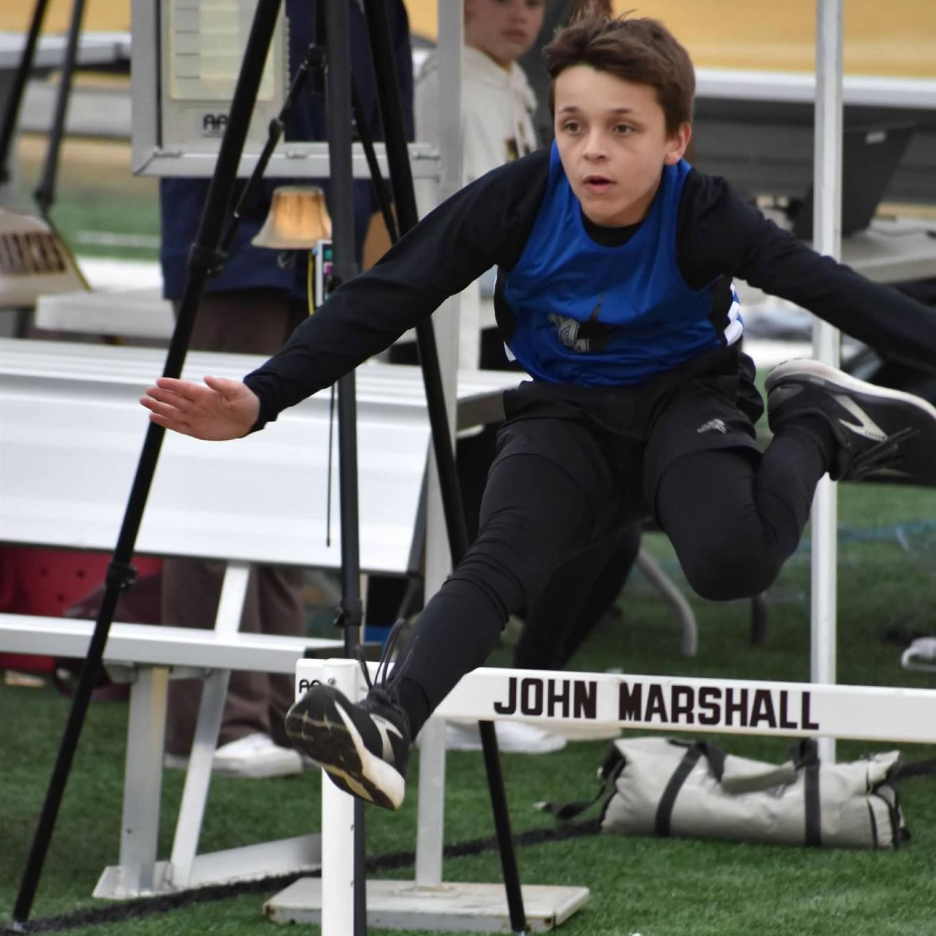 boy jumping hurdles
