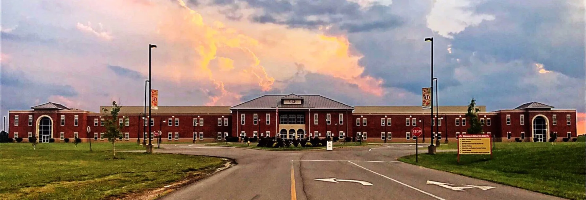 UHS red brick high school with clouds and sunlight 