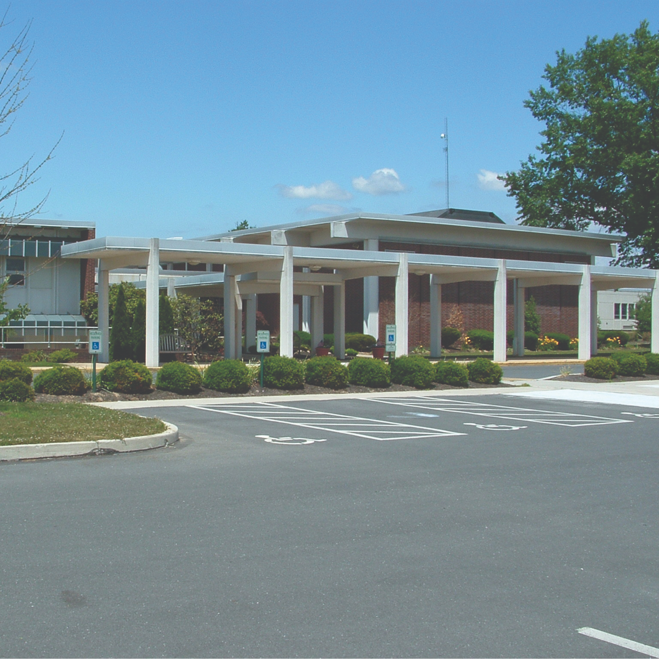 Picture of school with white columns in the front.