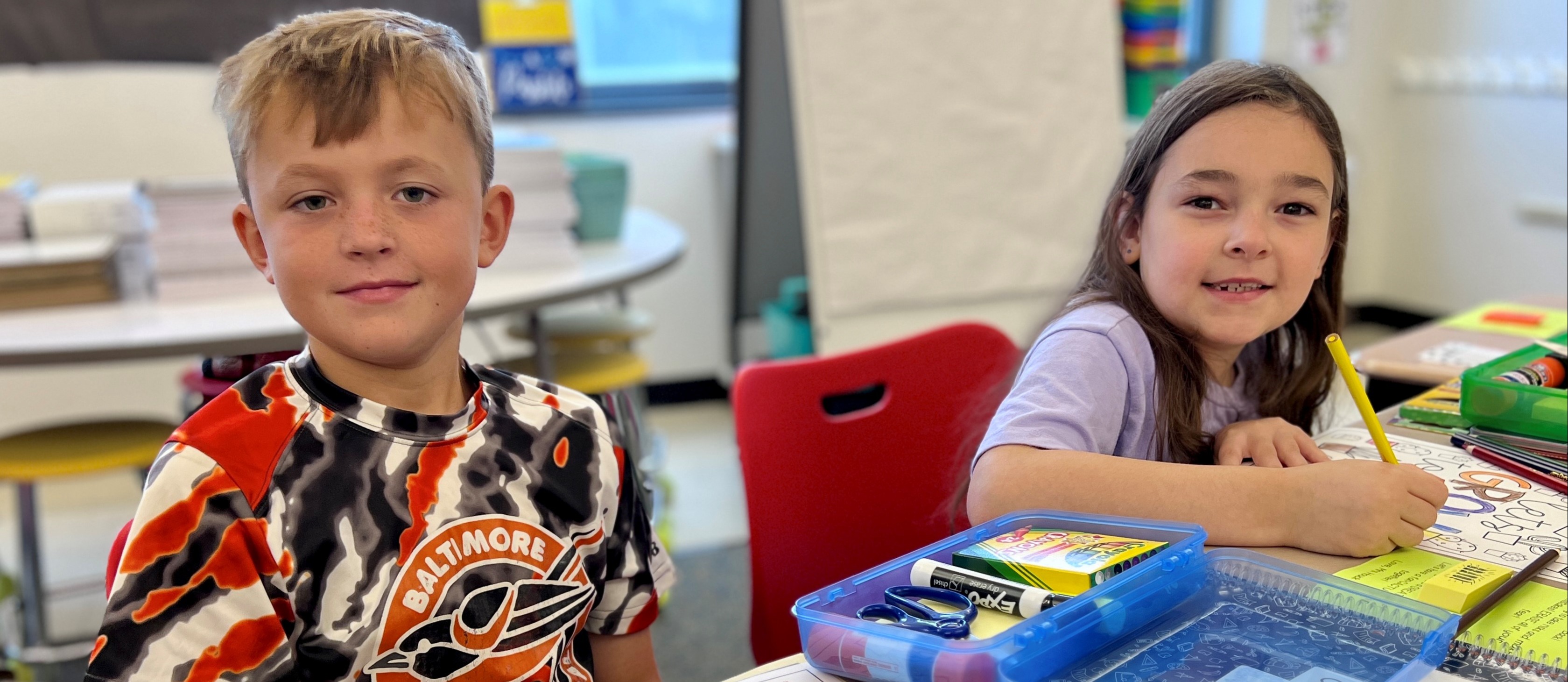 Picture of two students in a classroom.