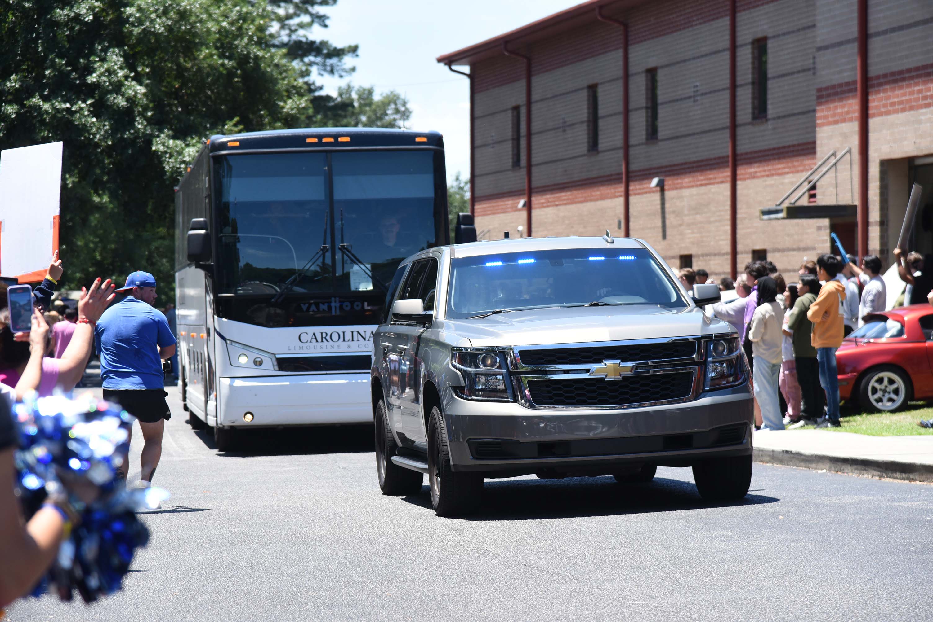 bus leaving with police escort